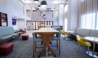 Hotel lobby with sofas, tables and chairs at the Hampton Inn & Suites North Attleboro.