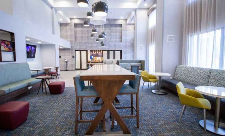 Hotel lobby with sofas, tables and chairs at the Hampton Inn & Suites North Attleboro.