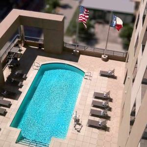 gorgeous outdoor pool with sunbeds and seating at Hampton Inn Houston Downtown.