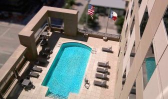 gorgeous outdoor pool with sunbeds and seating at Hampton Inn Houston Downtown.