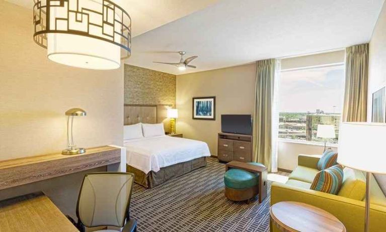 spacious king suite with work area and TV at Homewood Suites by Hilton Houston Downtown.