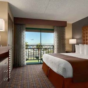 spacious king room with TV and work space at Embassy Suites by Hilton Los Angeles International Airport South.