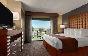 spacious king room with TV and work space at Embassy Suites by Hilton Los Angeles International Airport South.