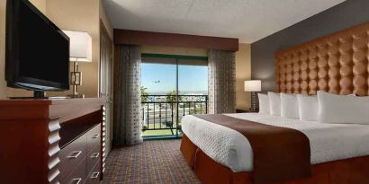 spacious king room with TV and work space at Embassy Suites by Hilton Los Angeles International Airport South.