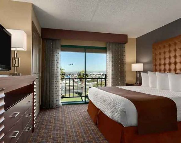 spacious king room with TV and work space at Embassy Suites by Hilton Los Angeles International Airport South.