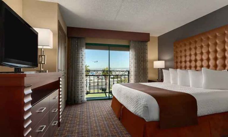 spacious king room with TV and work space at Embassy Suites by Hilton Los Angeles International Airport South.