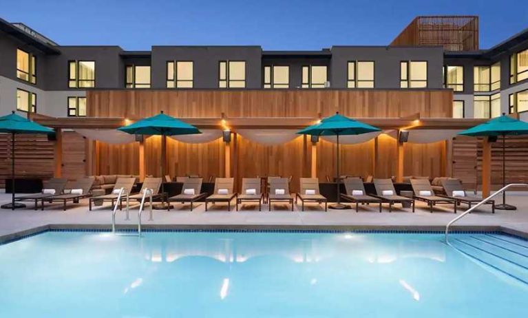 gorgeous outdoor pool with sun beds and seating area at Embassy Suites by Hilton Boulder.