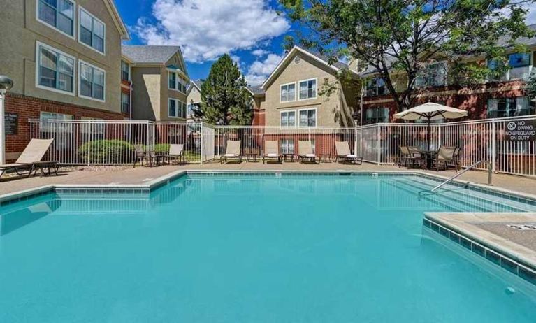 beautiful outdoor pool with sun beds and seating area at Homewood Suites by Hilton - Boulder.