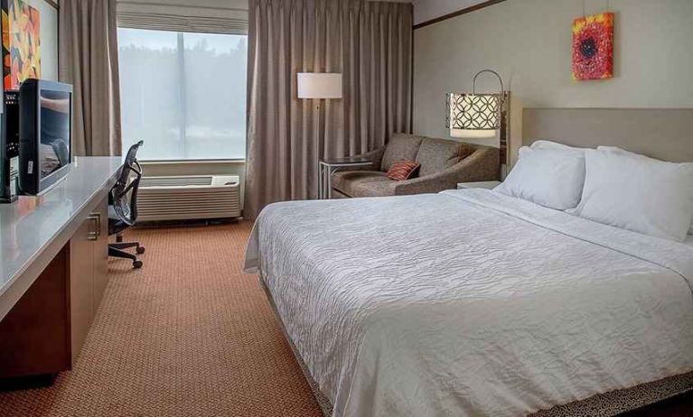 comfortable king delux room with TV and work desk ideal for working remotely at Hilton Garden Inn St. Louis/Chesterfield.