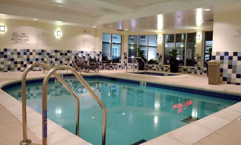 relaxing indoor pool with comfortable seating at Hilton Garden Inn St. Louis Airport.