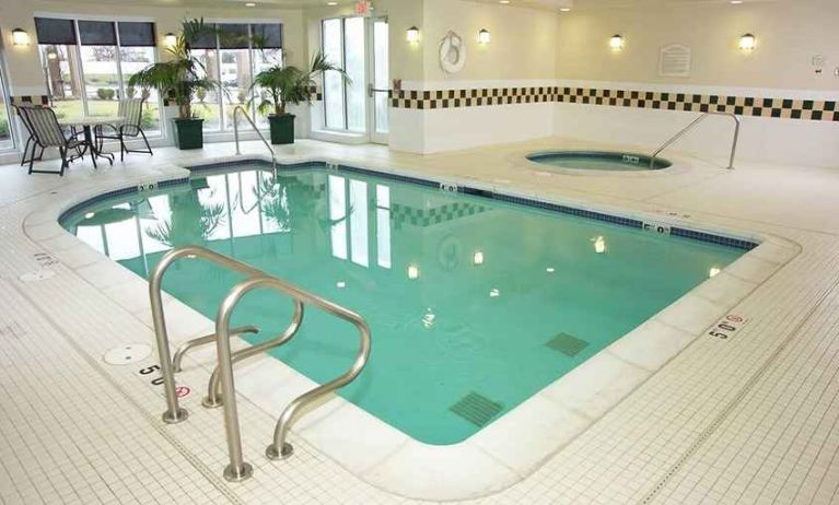 relaxing indoor pool with surrounding seating area at Hilton Garden Inn St. Louis/O'Fallon MO.