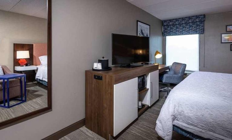 comfortable king room with TV, work desk, and lounge area at Hampton Inn Fall River/Westport.