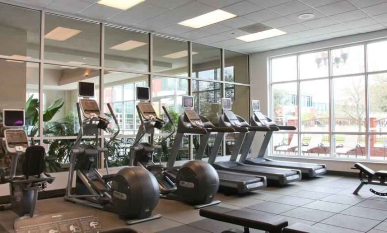 Fitness center with treadmills and windows at the Embassy Suites by Hilton Charleston Airport Convention Center.