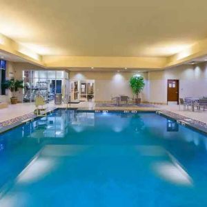 Indoor pool area with lounges at the Embassy Suites by Hilton Nashville - South-Cool Springs.