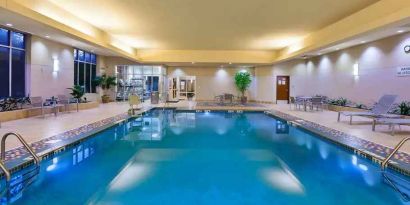 Indoor pool area with lounges at the Embassy Suites by Hilton Nashville - South-Cool Springs.