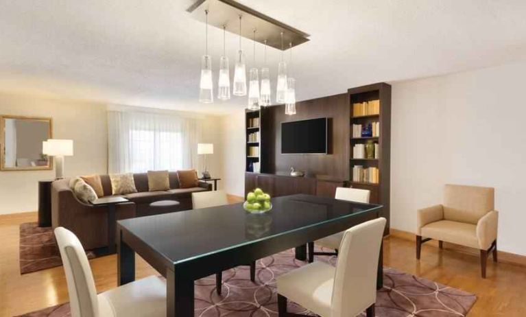 Spacious living room with working station at the Embassy Suites by Hilton Greenville Golf Resort Conference Center