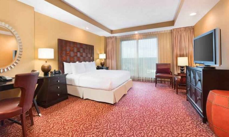 Spacious presidential suite with window, desk and TV screen at the Embassy Suites by Hilton Nashville SE Murfreesboro.