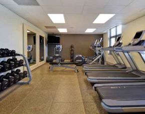 Fitness center with treadmills and weights at the Embassy Suites by Hilton Hot Springs Hotel & Spa.