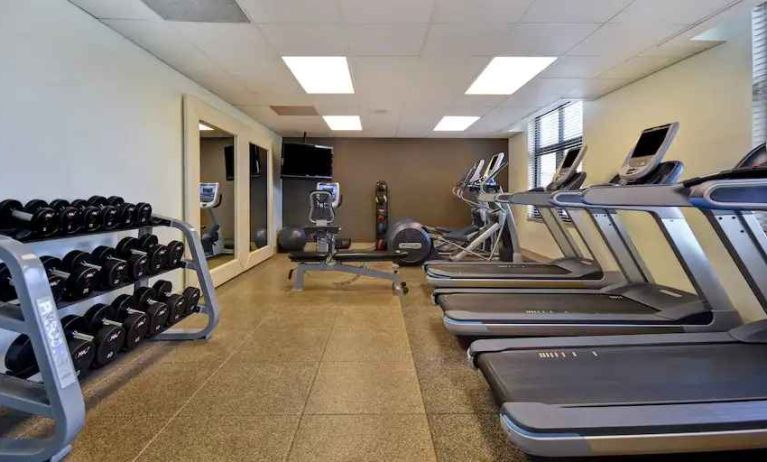 Fitness center with treadmills and weights at the Embassy Suites by Hilton Hot Springs Hotel & Spa.