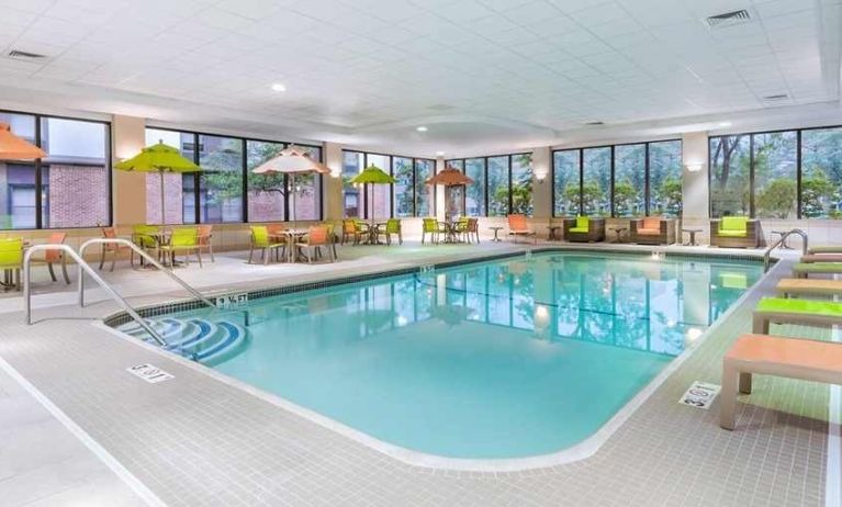 indoor pool with lots of natural light and surrounding seating area at Hampton Inn Boston/Marlborough.