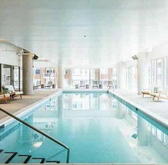 beautiful indoor pool with seating area at Hilton Garden Inn Denver Union Station.