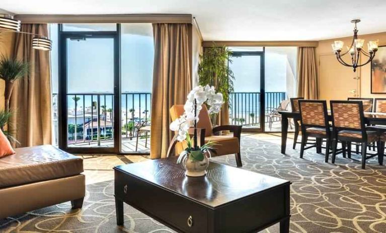 Spacious and elegant presidential room with sofa, table and view at the Hilton Galveston Island Resort.