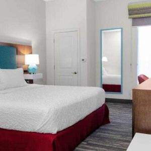 King bedroom with TV screen and window at the Hampton Inn Concord Bow.