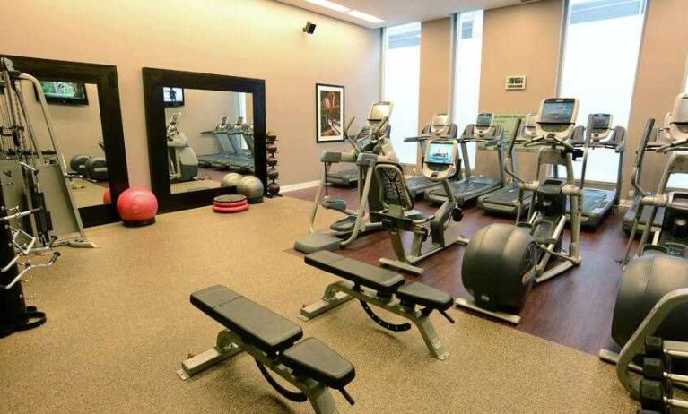 Fully equipped fitness center with mirrors at the Hilton Columbus Downtown.