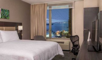 King bedroom with working station and city view at the Hilton Garden Inn Financial Center Manhattan Downtown, NY.