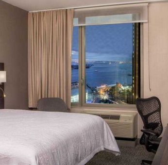 King bedroom with working station and city view at the Hilton Garden Inn Financial Center Manhattan Downtown, NY.