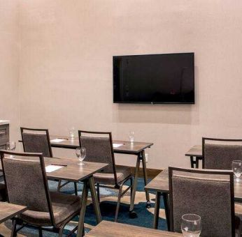 Meeting room with tables and chairs at the Hilton Garden Inn Financial Center Manhattan Downtown, NY.