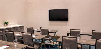 Meeting room with tables and chairs at the Hilton Garden Inn Financial Center Manhattan Downtown, NY.