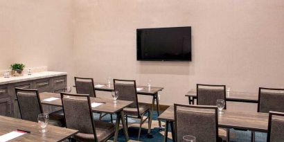 Meeting room with tables and chairs at the Hilton Garden Inn Financial Center Manhattan Downtown, NY.