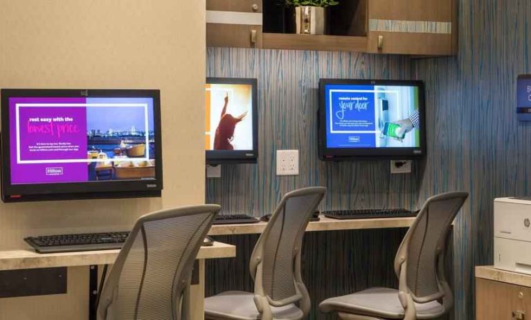 Working station with computers and printer at the Hilton Garden Inn Financial Center Manhattan Downtown, NY.