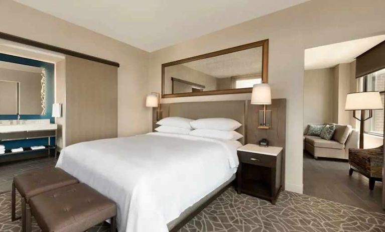 luxurious king suite with lounge area and work desk at Embassy Suites by Hilton Minneapolis Downtown.