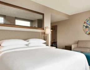 spacious king bedroom with natural light at Embassy Suites by Hilton Minneapolis Downtown.