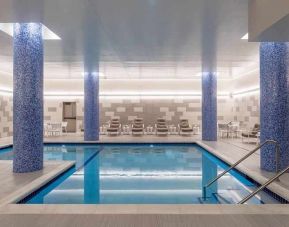 beautiful indoor pool with comfortable seating area at Embassy Suites by Hilton Minneapolis Downtown.