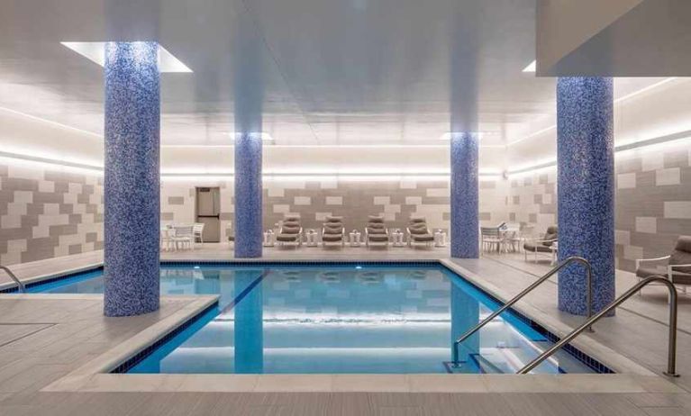 beautiful indoor pool with comfortable seating area at Embassy Suites by Hilton Minneapolis Downtown.