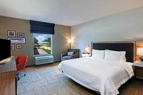 spacious king bedroom with work desk and natural light ideal for working remotely at Hampton Inn Bulverde Texas Hill Country.