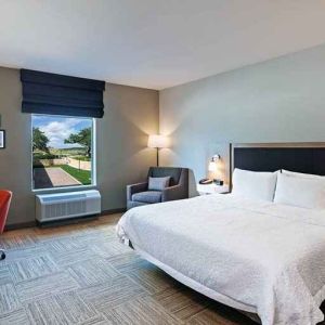 spacious king bedroom with work desk and natural light ideal for working remotely at Hampton Inn Bulverde Texas Hill Country.