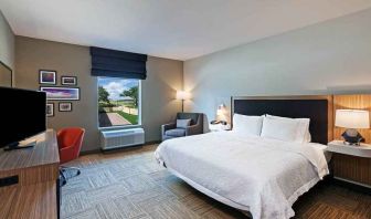 spacious king bedroom with work desk and natural light ideal for working remotely at Hampton Inn Bulverde Texas Hill Country.