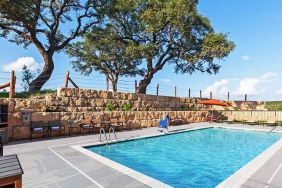 beautiful outdoor pool with comfortable seating area at Hampton Inn Bulverde Texas Hill Country.