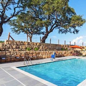 beautiful outdoor pool with comfortable seating area at Hampton Inn Bulverde Texas Hill Country.