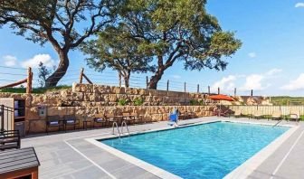 beautiful outdoor pool with comfortable seating area at Hampton Inn Bulverde Texas Hill Country.