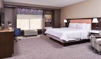 Spacious and bright king guestroom with window and desk at the Hampton Inn Albuquerque, University-Midtown (UNM).