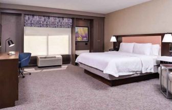 Spacious and bright king guestroom with window and desk at the Hampton Inn Albuquerque, University-Midtown (UNM).