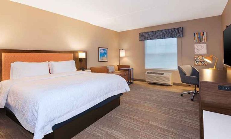 comfortable king room with TV and work desk at Hampton Inn Cape Cod Canal.