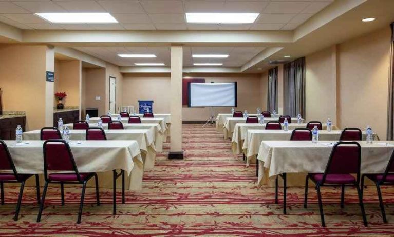 Large meeting room with tables and chairs at the Hampton Inn Albuquerque, University-Midtown (UNM).