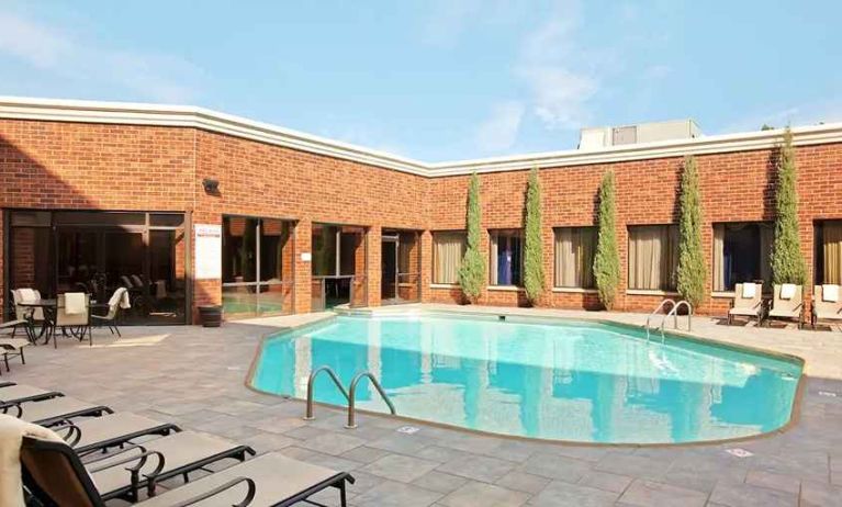 beautiful outdoor pool with comfortable seating area at DoubleTree by Hilton Hotel Cleveland - Independence.