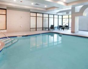 beautiful indoor pool with comfortable seating area at Embassy Suites by Hilton Seattle North Lynnwood.